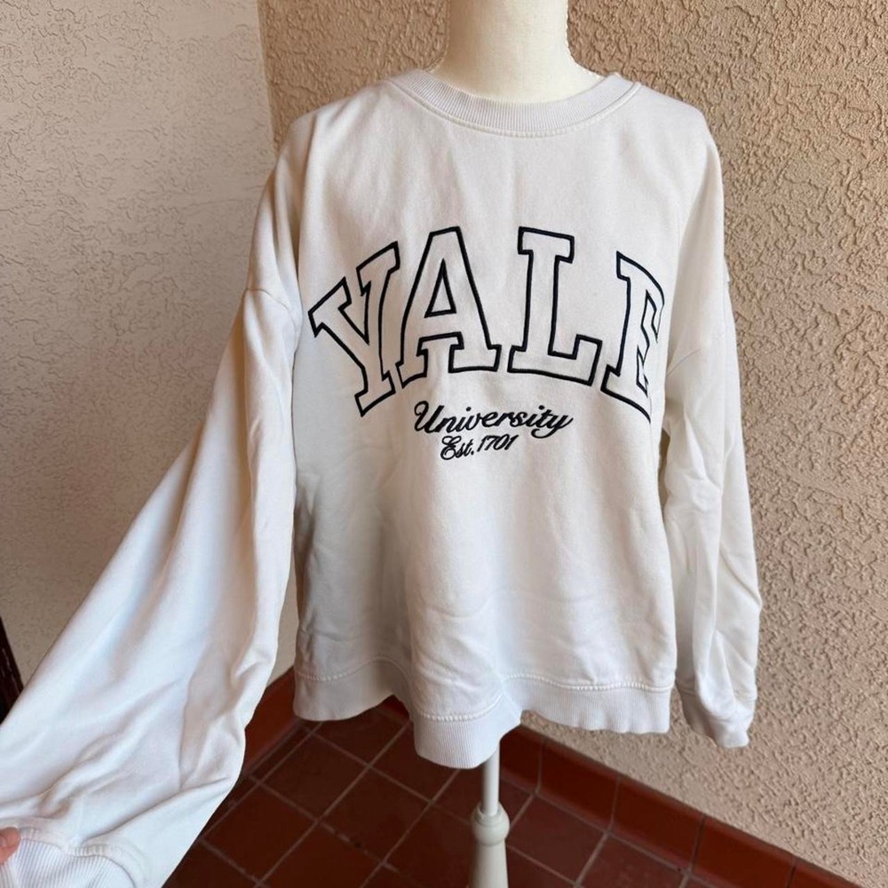 Yale University white crewneck sweatshirt.